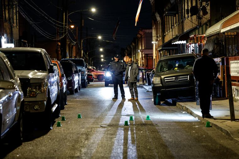 Police at the scene of a triple shooting on the 2800 block of North Reese Street on Monday in the Fairhill section of Philadelphia. Two teens delivering food for DoorDash were hit by stray bullets, police said. A 26-year-old man was killed.