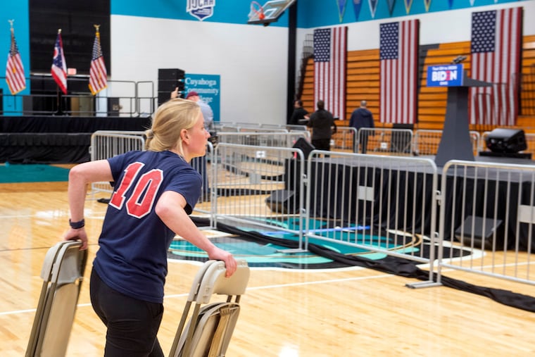 A worker carries chairs after a campaign rally for Democratic presidential candidate former Vice President Joe Biden was cancelled at Cuyahoga Community College Tuesday, March 10, 2020, in Cleveland, due to the coronavirus. In Pennsylvania, the pandemic has created uncertainty around whether the state will hold its primary on April 28 as planned, pinching underdog campaigns.