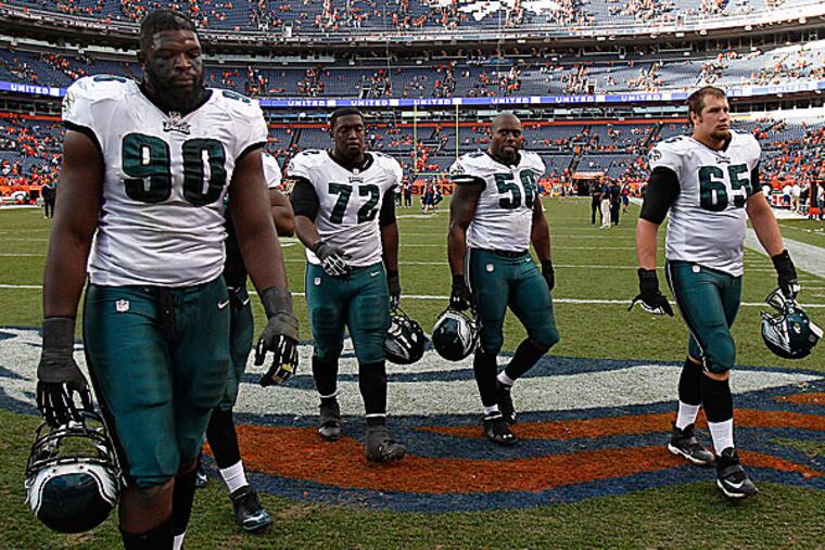 Eagles players leave the field after the loss to the Broncos. (David Maialetti/Staff Photographer)