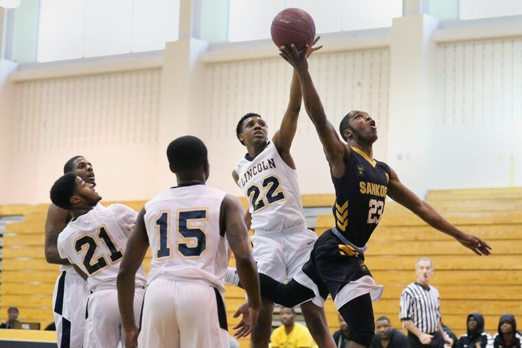 Sankofa’s Scott Spann (23) goes for a layup against Lincoln’s Tyree Corbett (22).
