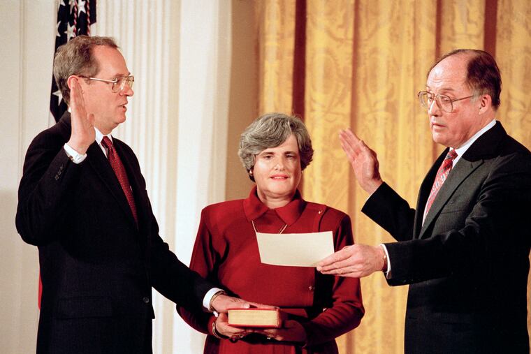 In this Feb. 18, 1988, file photo Anthony Kennedy, left, takes the constitutional oath as a Supreme Court Associate Justice from Chief Justice William Rehnquist at a White House ceremony in Washington. Holding the Bible is Kennedy's wife, Mary Kennedy. The 81-year-old Kennedy said Tuesday, June 27, 2018, that he is retiring after more than 30 years on the court.