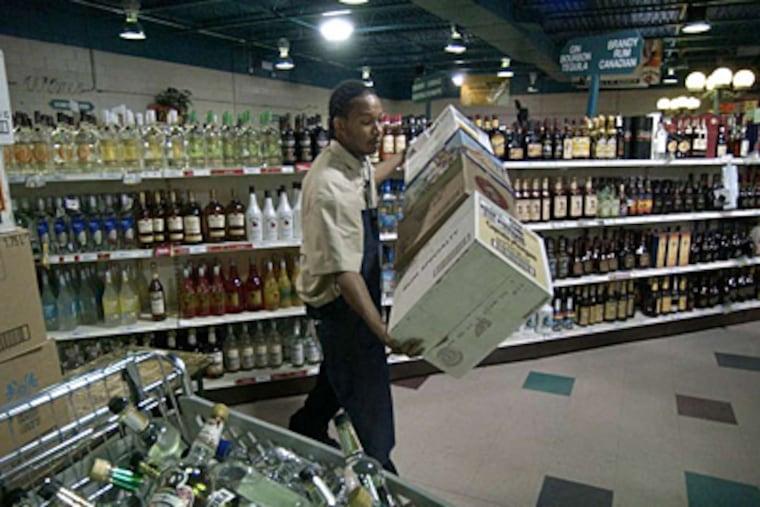 LCB employee Larry Smith stocking shelves in 2005 at the State Store in Franklin Mills, one of 613 that Pennsylvania operates. (Jonathon Wilson/ File Photograph)