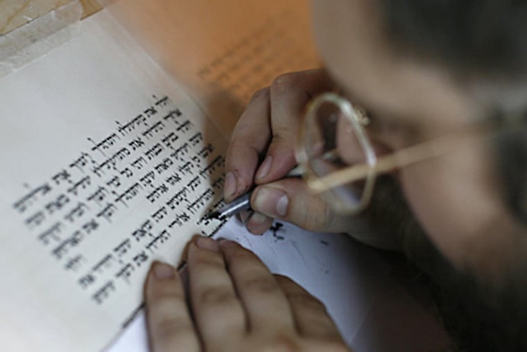 Rabbi Avraham Bloomenstiel works meticulously using traditional Jewish techniques to transcribe the Torah onto parchment with a quill at his home in Dallas, Texas. (Sonya N. Hebert/Dallas Morning News/MCT)