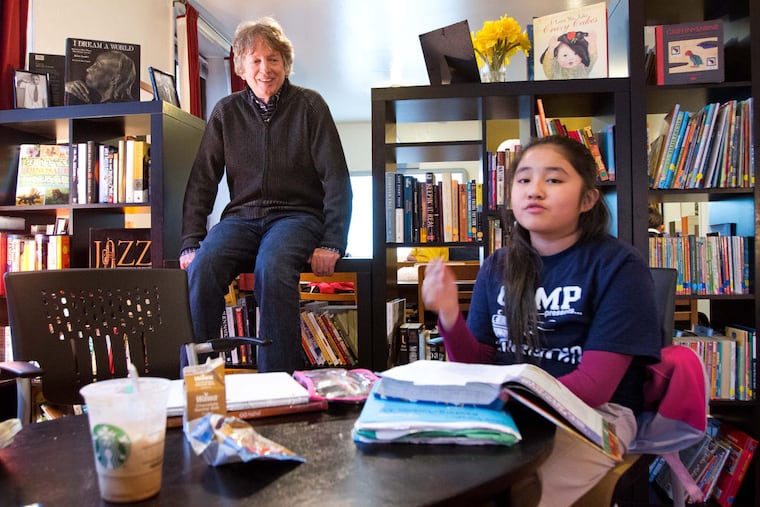 Director Tim Whitaker (left) and Mia Nguyen, 10 at the time, who was working at Mighty Writers.