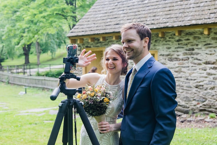 Jes Ebrahimzadeh and Adam Minichelli wave to their families, who were watching via Zoom.