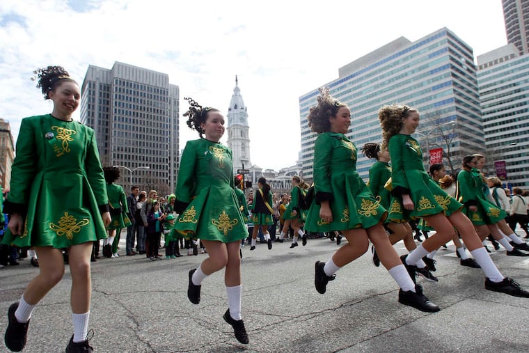 Stepping to it at the St. Patrick's Day Parade on the Parkway are members of the Nicholl School of Irish Dance from Yardley. Crowds were slow to arrive Sunday morning, maybe because of daylight saving time, but by afternoon, the streets were lined in green. Story on B1.