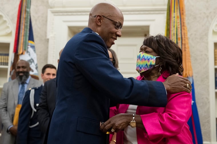 Gen. Charles Q. Brown Jr., after being sworn in as Chief of Staff of the Air Force, hugs his mother in the Oval Office of the White House.