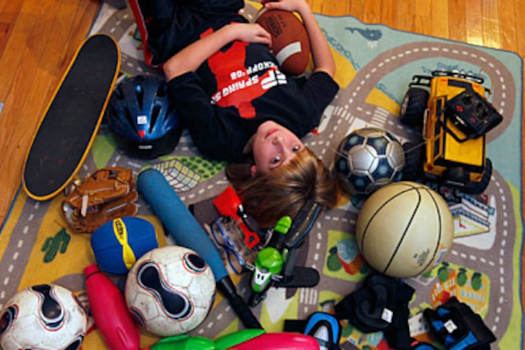 Noah Swindlehurst, 10, is getting rid of older toys, joining his family in paring back belongings and making donations and holding a garage sale. (Tom Wallace/Minneapolis Star Tribune/MCT)