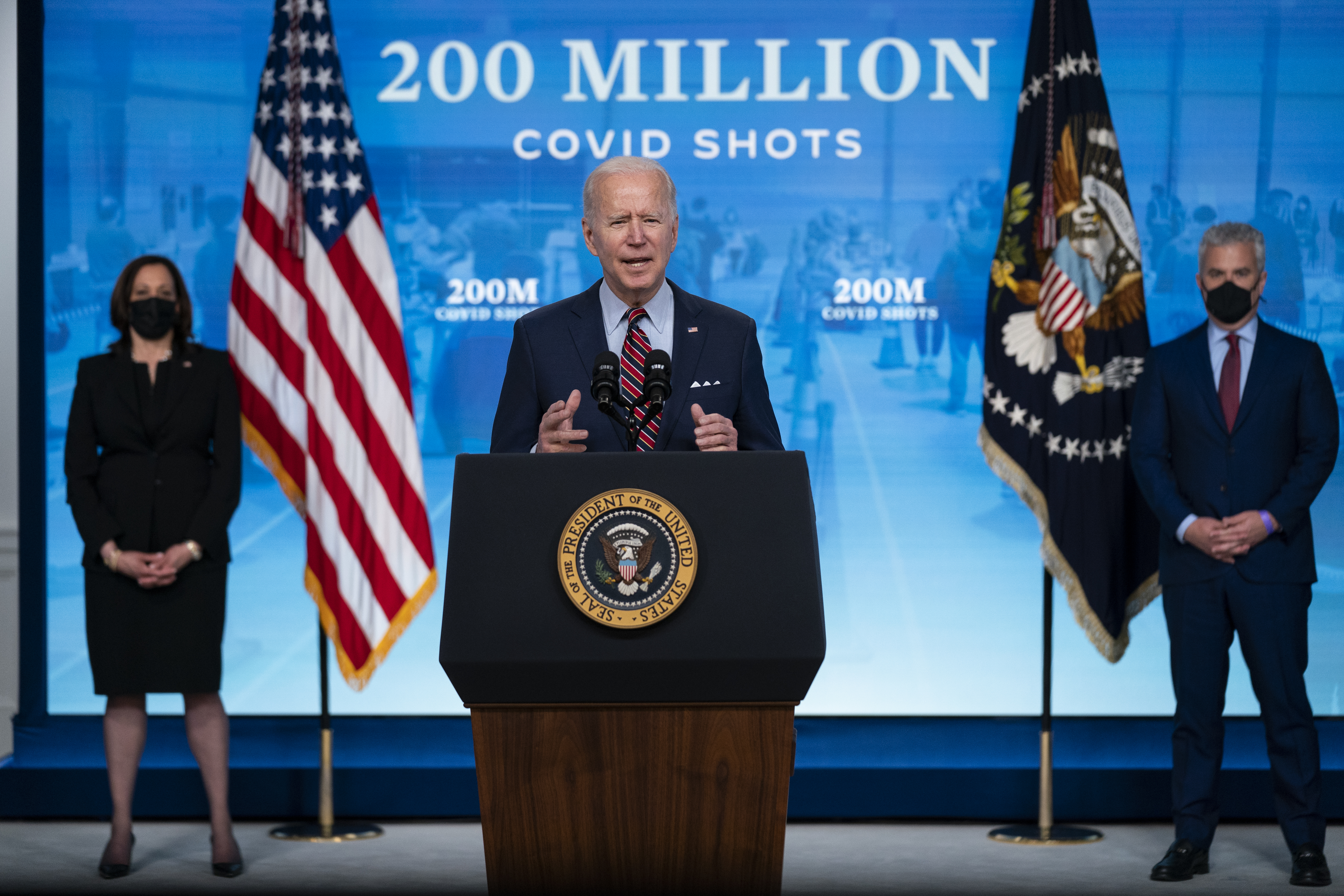 Vice President Kamala Harris, left, and White House COVID-19 Response Coordinator Jeff Zients, right, listen as President Joe Biden speaks about COVID-19 vaccinations at the White House on Wednesday.