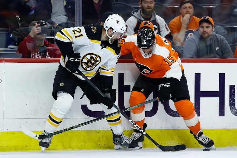 Boston's Nick Ritchie (left) and the Flyers' Matt Niskanen battling for the puck during a late-season game. Niskanen prefers a 16-team playoff format over a 24-team field.