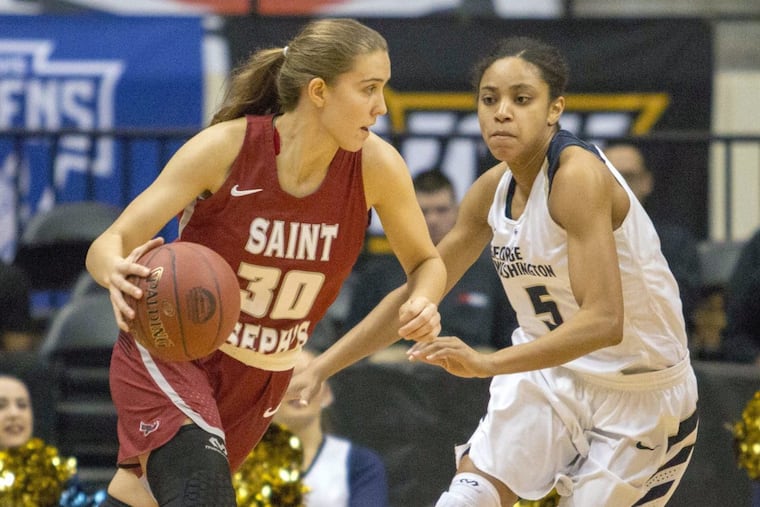 Saint Joseph's Sarah Veilleux finds an opening against George Washington guard Brianna Cummings during the Atlantic Ten final.