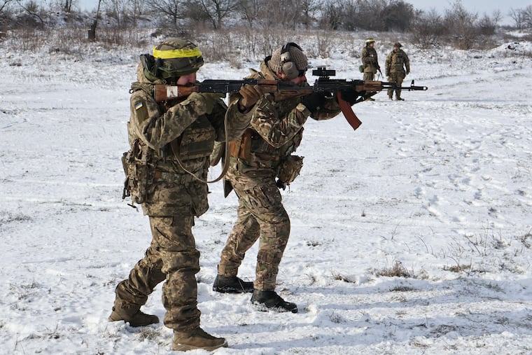 In this photo provided by Ukraine's 65th Mechanized Brigade press service, recruits perform drills at a training ground in the Zaporizhzhia region of Ukraine this week.
