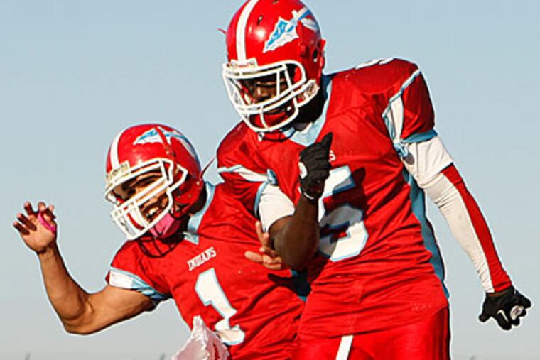 Pennsauken quarterback Manny Cortez celebrates with Amar Williams after throwing him a touchdown pass. (Ron Cortes/Staff Photographer)