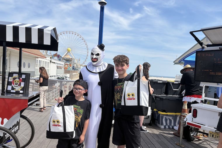 Carlo Gambino, 8, and his brother Nicholas, 10, were first in line to pose with Art the Clown of Spirit Halloween and the Terrifier movies. They run the Spook 365 youtube channel.