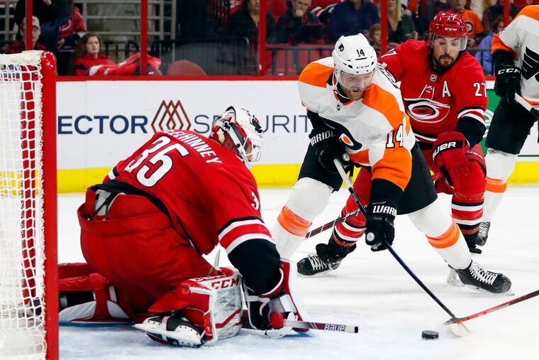 Sean Couturier attempts a shot on Carolina goaltender Curtis McElhinney during the second period of the Flyers' 3-1 loss to the Hurricanes Monday. (Karl B DeBlaker / AP Photo)