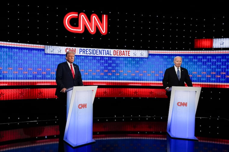 President Joe Biden and Republican presidential candidate former President Donald Trump stand during a break in a presidential debate hosted by CNN in Atlanta.