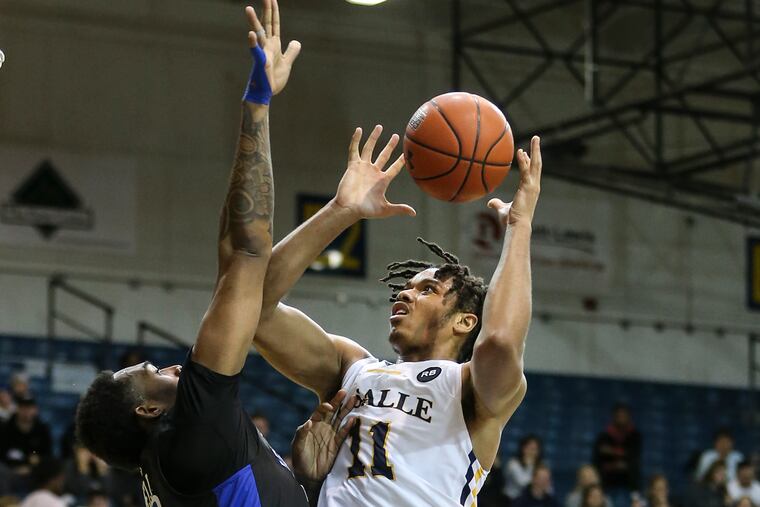 LaSalle's Ed Croswell shoots over Saint Louis' Jimmy Bell Jr. during the 1st half at the Tom Gola Arena on Wednesday.