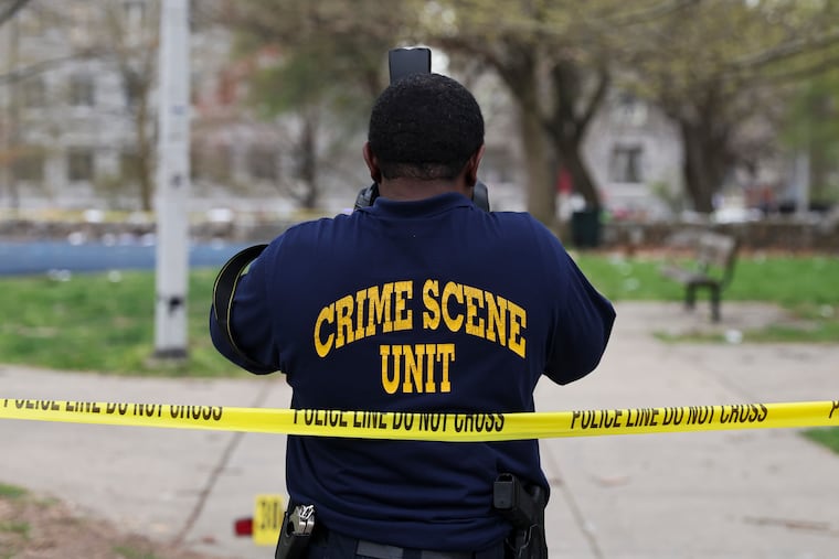 The Crime Scene Unit photographs evidence after multiple people were shot at an Eid al-Fitr gathering at Clara Muhammad Square on April 10.