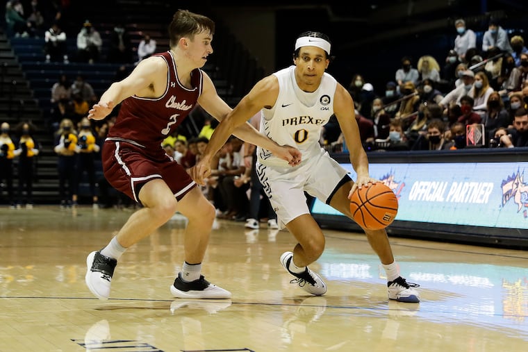Drexel guard Coletrane Washington being guarded by College of Charleston's Reyne Smith on Feb. 26. Washington is a captain this season.