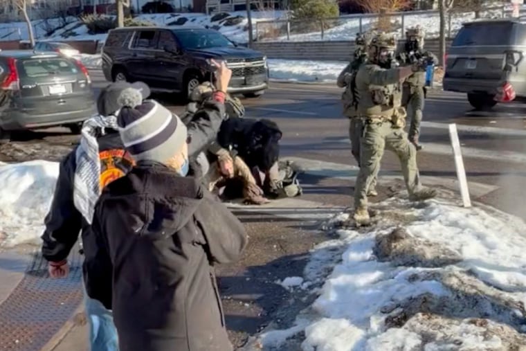 This image taken from video by Max Shapiro shows Alex Pretti (center, left) scuffling with federal immigration officers in Minneapolis on Jan. 13.