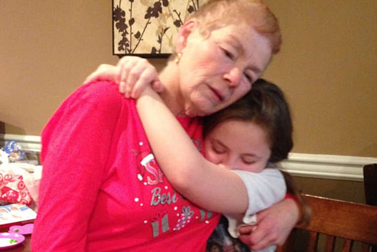 Anna Pozzi is comforted by her granddaughter Olivia, 11, as she talks about the hit-and-run death of her daughter, Theresa