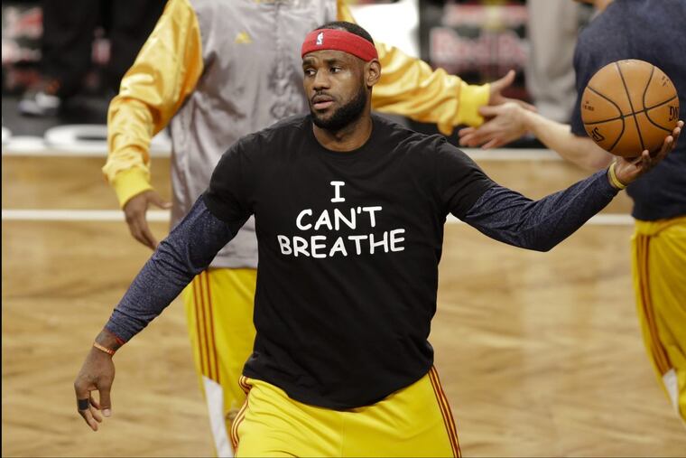 In this Dec. 8, 2014 file photo, Cleveland Cavaliers’ LeBron James wears a T-shirt reading “I Can’t Breathe” protesting the death of Eric Garner, during warms up before an NBA basketball game against the Brooklyn Nets in New York.