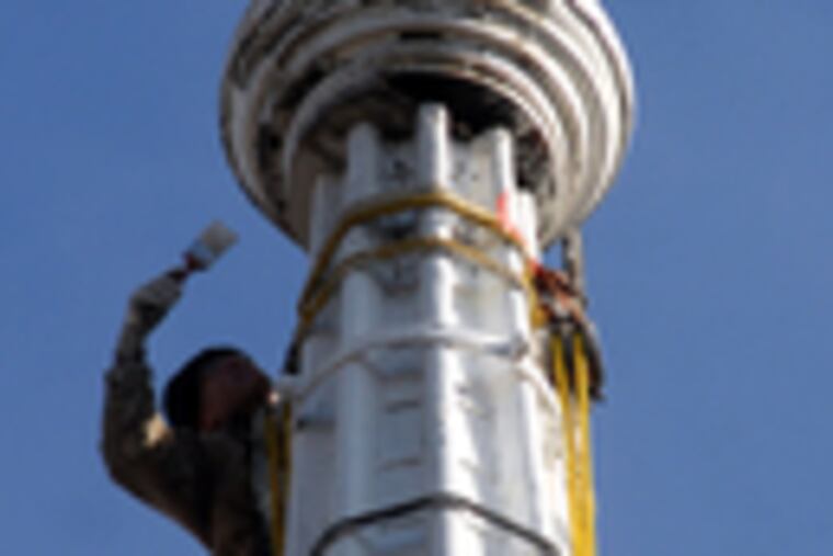 Frank Kenny applies primer to the spire. The 250th anniversary of the church's groundbreaking will be celebrated next year.