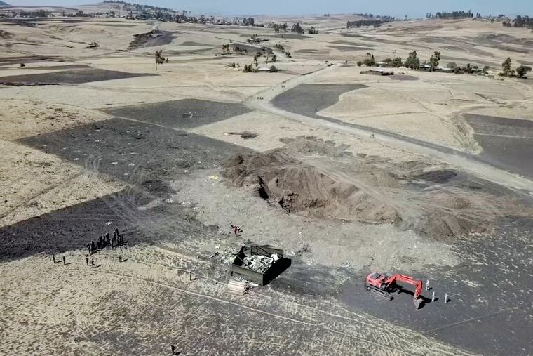 This aerial image made from video shows recovery work continuing at the scene where the Ethiopian Airlines Boeing 737 Max 8 crashed shortly after takeoff on Sunday killing all 157 on board, near Bishoftu, south-east of Addis Ababa, in Ethiopia Friday, March 15, 2019. Analysis of the flight recorders has begun in France, the airline said Friday, while in Ethiopia officials started taking DNA samples from victims' family members to assist in identifying remains.