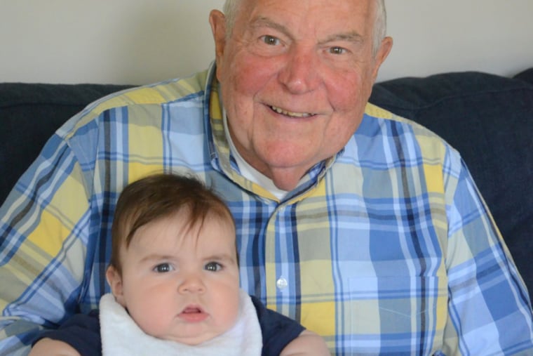 Edward Weinrich with one of his 16 grandchildren.
