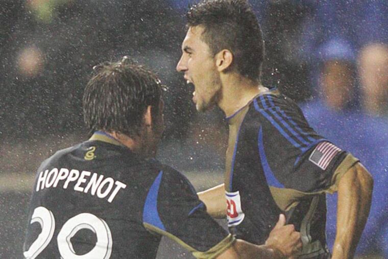 Union's Michael Farfan (21) celebrates with teammate Antoine Hoppenot (29) after scoring a direct free kick to go up one on Chivas USA during the second half at PPL Park. (Steven M. Falk/Staff Photographer )