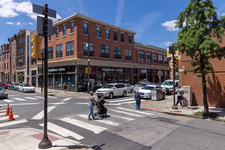 Pedestrian and vehicle traffic at Ninth and South Streets, where a Philadelphia police officer struck a pedestrian on Tuesday.