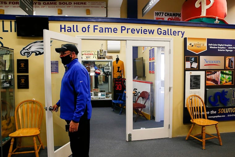 Spike's Trophies CEO Keith Baldwin stands at the front entrance to the Philadelphia Sports Hall Fame preview gallery in Northeast Philadelphia. About to lay off all his employees, Baldwin transformed Spike's into a call center for COVID-19 patients.