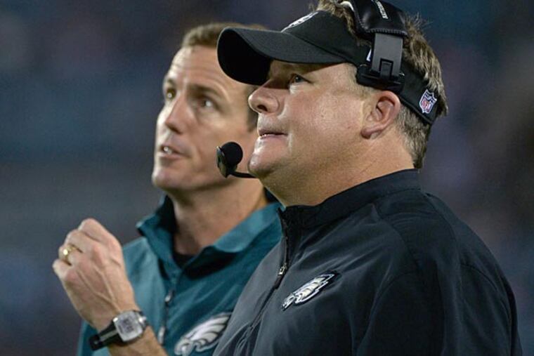 Philadelphia Eagles head coach Chip Kelly, right, and special teams coordinator Dave Fipp watch from the sideline during the second half of an NFL preseason football game against the Jacksonville Jaguars in Jacksonville, Fla., Saturday, Aug. 24, 2013. (AP Photo/Phelan M. Ebenhack)