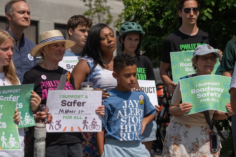 Jasmine Hoffman, and Eshad Hoffman, (center), at a rally to
advocate for safer bike infrastructure on Market Street in University City. He said its suggested steps to make the stretch safer could be implemented within 60 days.