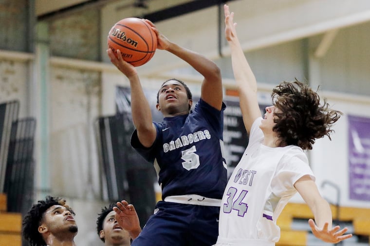 Timber Creek’s Faizan Carter shoots over Cherry Hill West’s Lucas Flynn during a recent game.