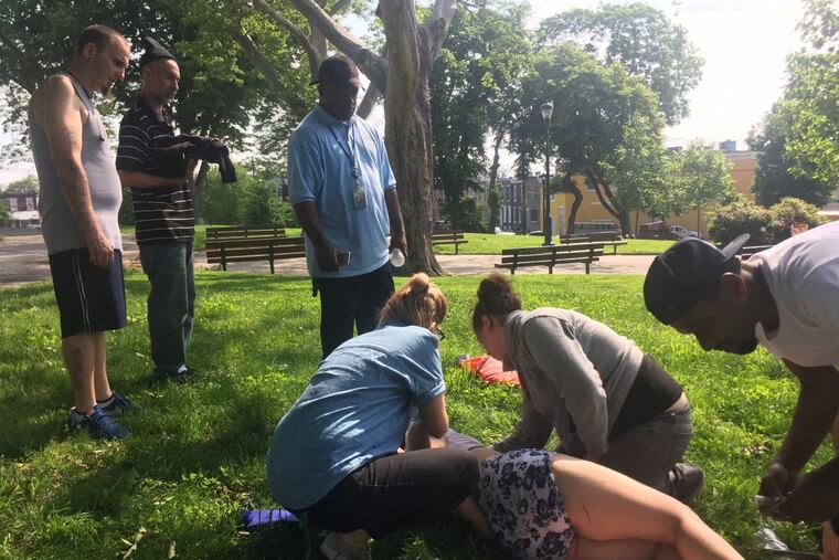 Librarian Chera Kowalski tends to an overdose victim recently outside the McPherson Square Library.