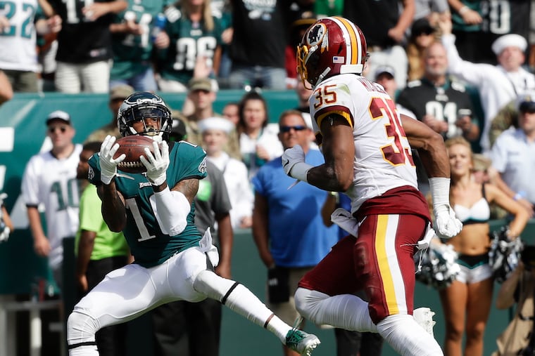 DeSean Jackson pulls in a third-quarter touchdown catch behind Washington safety Montae Nicholson on Sunday.