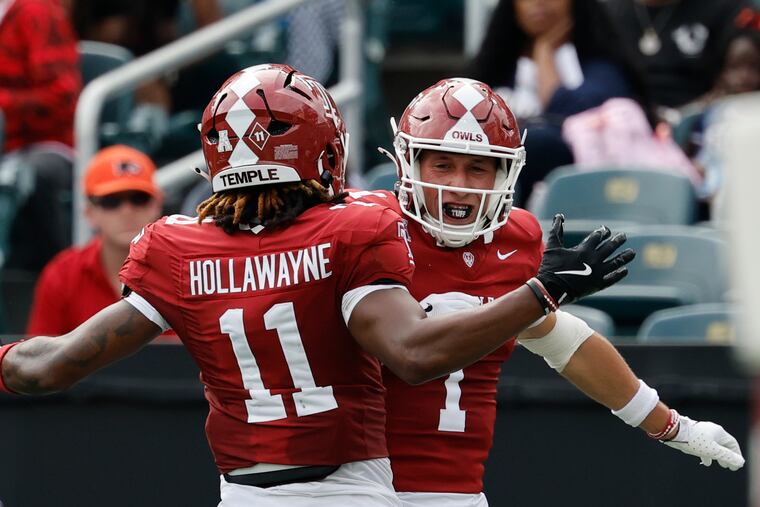 Temple wide receiver Kajiya Hollawayne, seen here with teammate Colin Chase in a game earlier this season, scored three touchdowns to lead the Owls past Tulsa on Saturday.