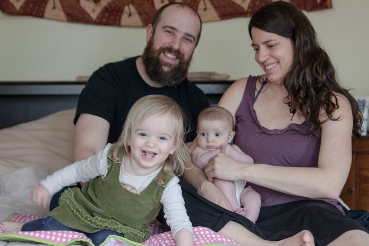 Brian Eckenrode and Sarah Trohaugh with Violet (left) and Luci.