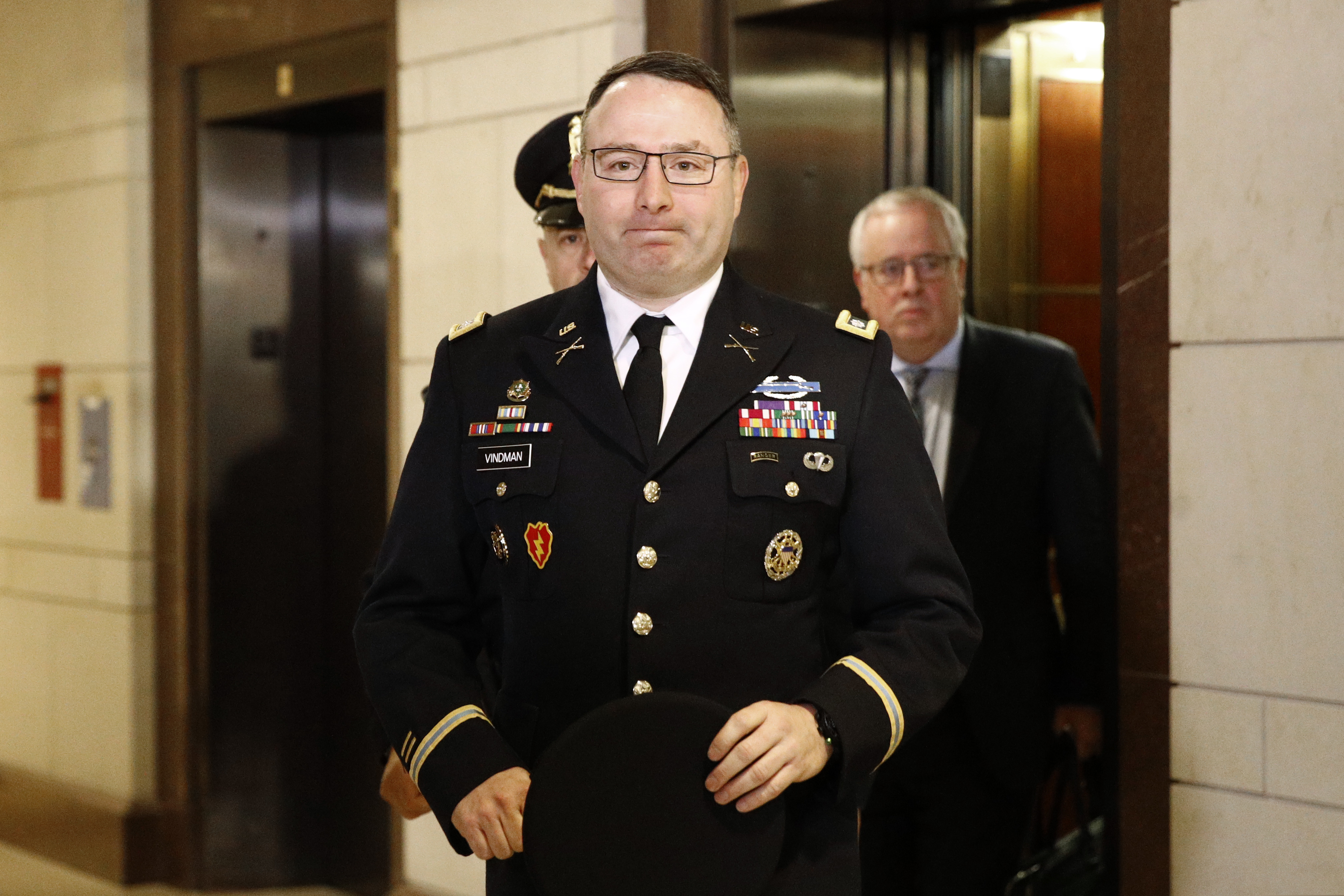 In this Oct. 29, 2019, file photo, Army Lt. Col. Alexander Vindman, a military officer at the National Security Council, center, arrives on Capitol Hill in Washington.