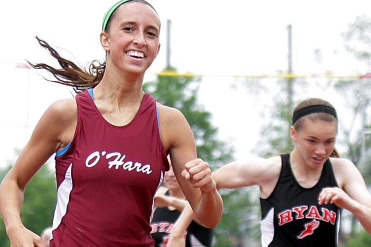 Kayla Keir of Cardinal O’Hara smiles as she hits the finish line to
win the girls’ 300-meter hurdles Saturday at the Catholic League track
and field championships at Upper Darby. (Lou Rabito/Staff)