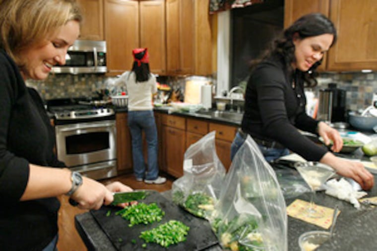 Warm friendship and frozen family fare with flair top the menu when (from left) Sarah Wagner, Rhea Lee and Susanna Schweikert get together to prepare ready-to-serve meals.