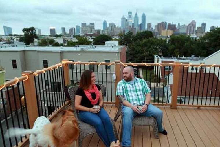 Lauren and Shawn League kick back on their roof deck at their home on Manton Street.