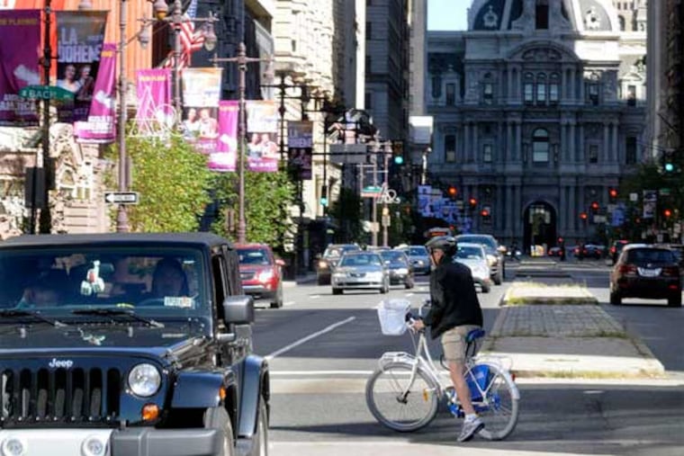 Carl Dranoff pedals one of his bike-share bicycles up South Broad Street. The bikes are free for use by the approximately 2,000 tenants of his rental buildings. (Tom Gralish / Staff Photographer)