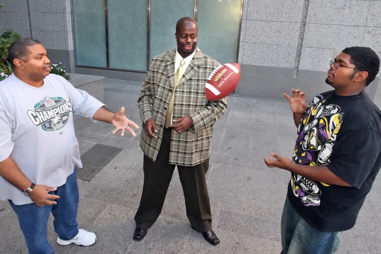 Chad Dion Lassiter, behavioral interventionist at Children's Hospital, is flanked by Chris Mills (left) and his son, Elliott, 15, who are part of the PAL program the hospital.