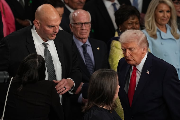 President Donald Trump passes Sen. John Fetterman, D-Pa., as he departs after delivering the State of the Union address to a joint session of Congress in the House chamber at the U.S. Capitol in Washington, Tuesday, Feb. 24, 2026.