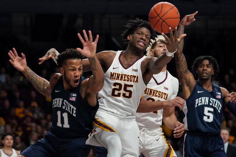 Minnesota's Daniel Oturu (25) reaching for a rebound against Penn State's Lamar Stevens (11) in the second half Jan. 15, as Minnesota's Jarvis Omersa (21) and Penn State's Jamari Wheeler (5) look on.