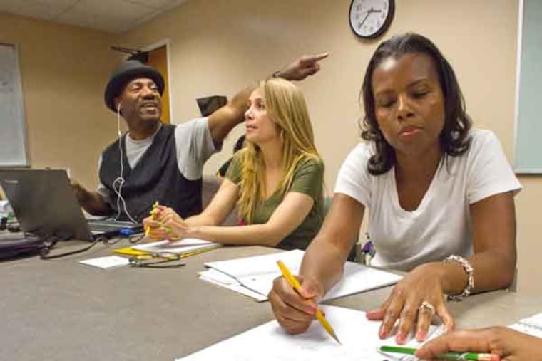Lester Owens (left), math professor at Camden County College, tutors Algebra students (center) Zenaida Rivera, of Camden, and Sherise Payton, of Blackwood during a session at Camden County Library at Voorhees, September 21, 2013. ( DAVID M WARREN / Staff Photographer )