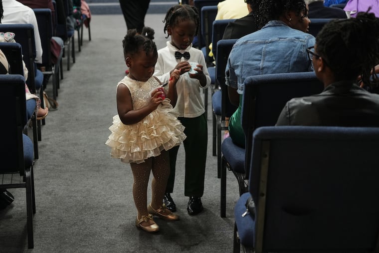 Children walk the aisles of the Word of Life Center church, a center for the Haitian community, during a service in Salisbury, Md. Sunday, Aug. 2, 2026.