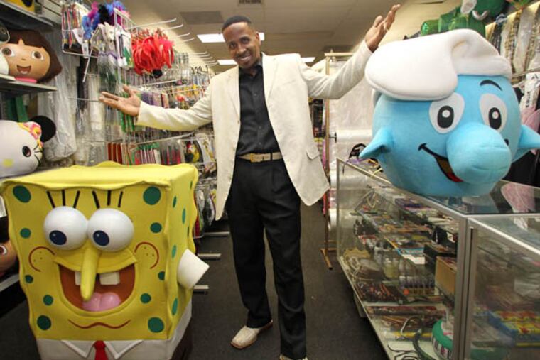 Derek Lee, owner of D & J Costumes in Northeast Philadelphia, stands next to costume in his shop on Wednesday, October 16, 2013. ( Yong Kim / Staff Photographer )